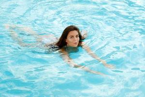 mulher feliz nadar na piscina foto