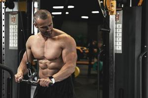 fisiculturista muscular durante seu treino no ginásio foto