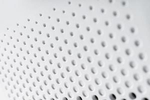 superfície de plástico de alta tecnologia de fundo abstrato com buracos e círculos foto