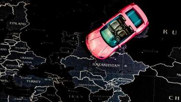minahasa, indonésia dezembro de 2022, carro de brinquedo rosa sobre o mapa foto