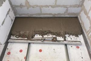 reboco de concreto no chão na construção da casa foto