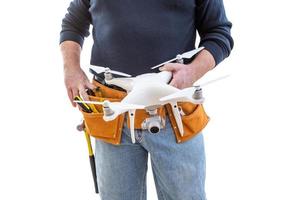 trabalhador da construção civil e piloto de drone com cinto de ferramentas segurando drone isolado no fundo branco foto