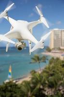 Drone quadricóptero do sistema de aeronaves não tripuladas no ar sobre a praia de Waikiki, no Havaí. foto