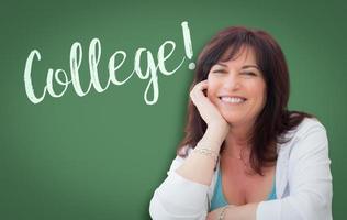 faculdade escrita na lousa verde atrás de uma mulher sorridente de meia idade foto
