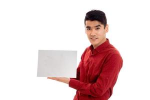 elegante modelo masculino morena na camisa vermelha posando com cartaz vazio isolado no fundo branco foto