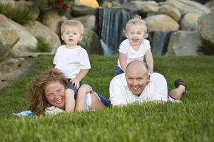 família jovem feliz com retrato de gêmeos no parque foto