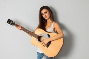 mulher morena com guitarra sorrindo foto