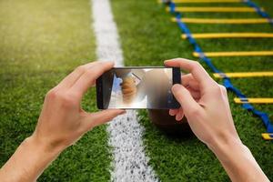 homem de apostas através de seu telefone inteligente no estádio foto