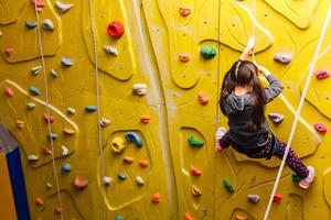 menina subindo no ginásio de escalada ao ar livre foto