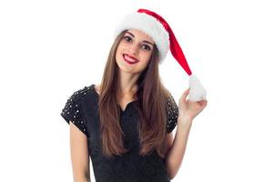menina morena de beleza com chapéu de Papai Noel foto