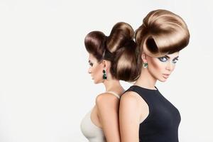 duas belas mulheres no estúdio. ambos com penteado criativo e maquiagem legal foto