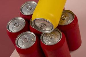 latas de refrigerante vermelhas frias com uma amarela para uso conceitual foto