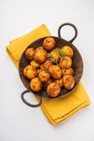 Batatas Bombay assadas caseiras. Batatinhas fritas ou aloo com sementes de jeera e coentro em tigela foto