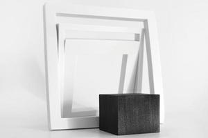 pódio preto com formas geométricas simples brancas sobre fundo branco. pódio para produto, apresentação cosmética. maquete criativa. pedestal ou plataforma para produtos de beleza. foto