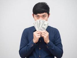 homem asiático mostra dinheiro fecha o rosto no fundo branco, empresário fecha o rosto com dinheiro do dólar foto