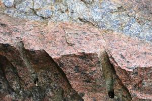 feche a vista em uma textura de granito e parede de pedra em alta resolução. foto