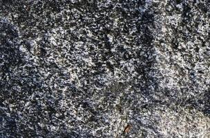 feche a vista em uma textura de granito e parede de pedra em alta resolução. foto