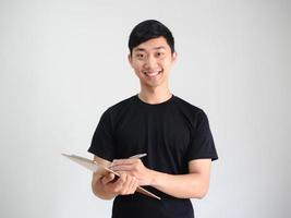 jovem camisa preta segurando a prancheta de madeira e caneta prata na mão e sorriso feliz retrato sobre fundo branco isolado foto