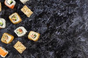 conjunto de sushi e maki na mesa de pedra. vista superior com espaço de cópia foto