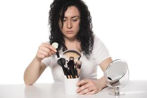 closeup retrato de mulher com pincel de maquiagem perto do rosto foto