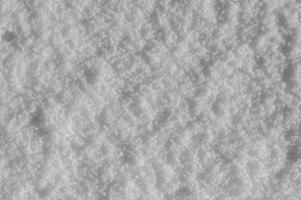 fundo de neve do inverno, cristais de gelo brilhando na neve, textura de natal, flocos de neve espumantes no monte de neve. foto
