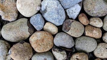 textura de cascalho de pedra redonda para fundo, textura de seixo natural foto