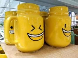 copo de cerâmica amarelo com ícone de sorriso, copo de vidro muito fofo foto