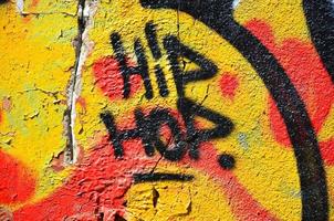 fragmento de um velho grafite colorido desenhando na parede. imagem de fundo como uma ilustração de arte de rua, vandalismo e pintura de parede com tinta aerossol foto