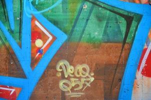 fragmento de um velho grafite colorido desenhando na parede. imagem de fundo como uma ilustração de arte de rua, vandalismo e pintura de parede com tinta aerossol foto