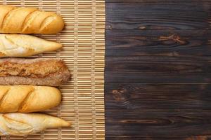 variedade de baguetes francesas frescas em uma mesa de madeira foto