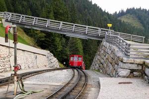 viajar para sankt-wolfgang, áustria. a estrada de ferro com um trem sob a ponte na vista das montanhas. foto