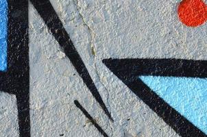 a parede velha, pintada em grafite colorido desenhando tintas aerossol azuis. imagem de fundo sobre o tema do desenho de graffiti e arte de rua foto