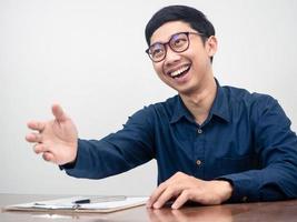 homem positivo usar óculos gesto apertar a mão sorriso feliz sobre entrevista foto