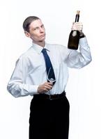 homem de negócios com um copo e uma garrafa de vinho nas mãos em um fundo branco e isolado foto