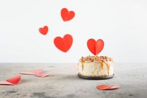 cheesecake bento pequeno decorado com topper de pequenos corações. conceito de dia dos namorados foto