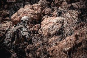 soldados das forças especiais em guerras no deserto, povo tailandês, soldado do exército usa laptop para ver mapa com satélite, usando rádio para comunicação durante operação militar foto