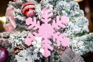 árvore de natal com floco de neve é decorada com bola, presentes e presente em tema rosa para evento de natal e ano novo foto