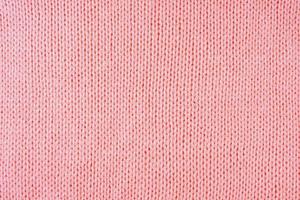 fundo de textura de tecido de lã malhas vermelho brilhante. pano de fundo abstrato têxtil foto