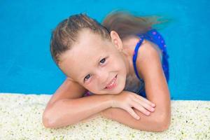 retrato de menina sorridente em uma piscina