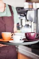 barista segurando uma bandeja de café foto