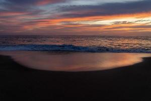 pôr do sol na praia do oceano pacífico em todos santos baja california méxico foto