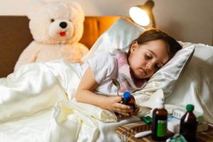 menina com doença na cama foto