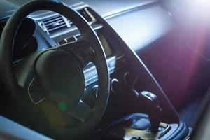 interior de carro de luxo escuro - volante, alavanca de câmbio e painel foto