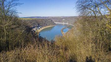 imagem panorâmica da rocha loreley no rio reno tirada do lado oposto do reno sob céu azul e sol foto