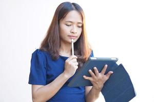 mulher asiática olhando para um monitor de computador portátil e elaborar um plano de negócios foto