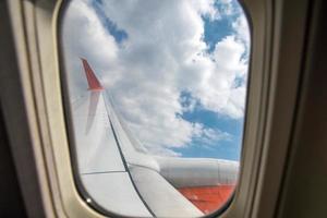 nuvens brancas e céu azul vista da janela de um avião de passageiros foto