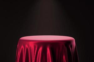 pano de cetim vermelho na mesa de pódio circular para exibição de produtos de luxo elegante com ilustração de renderização 3d de fundo volumétrico escuro foto