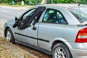 carro danificado estacionado na estrada da cidade foto