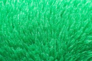 textura têxtil fofa verde. closeup de fundo peludo fralda. foto