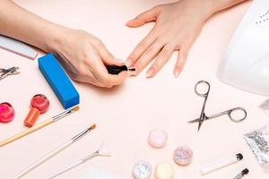 mãos de uma garota fazendo manicure em casa, close-up de mãos. A vista do topo foto